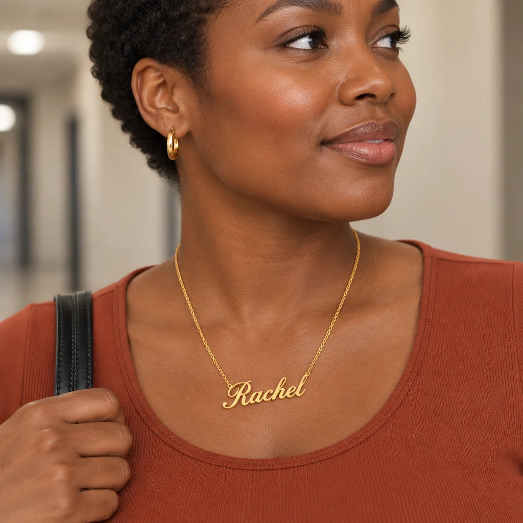 A gold stainless-steel personalized name necklace with a fine chain and cursive pendant, large and s