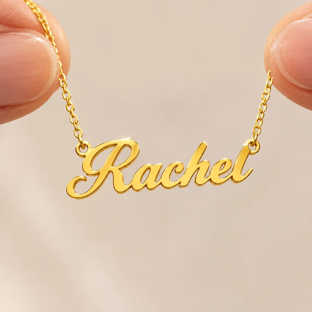 A polished gold stainless-steel cursive name pendant attached to its fine chain, exact delicate lett