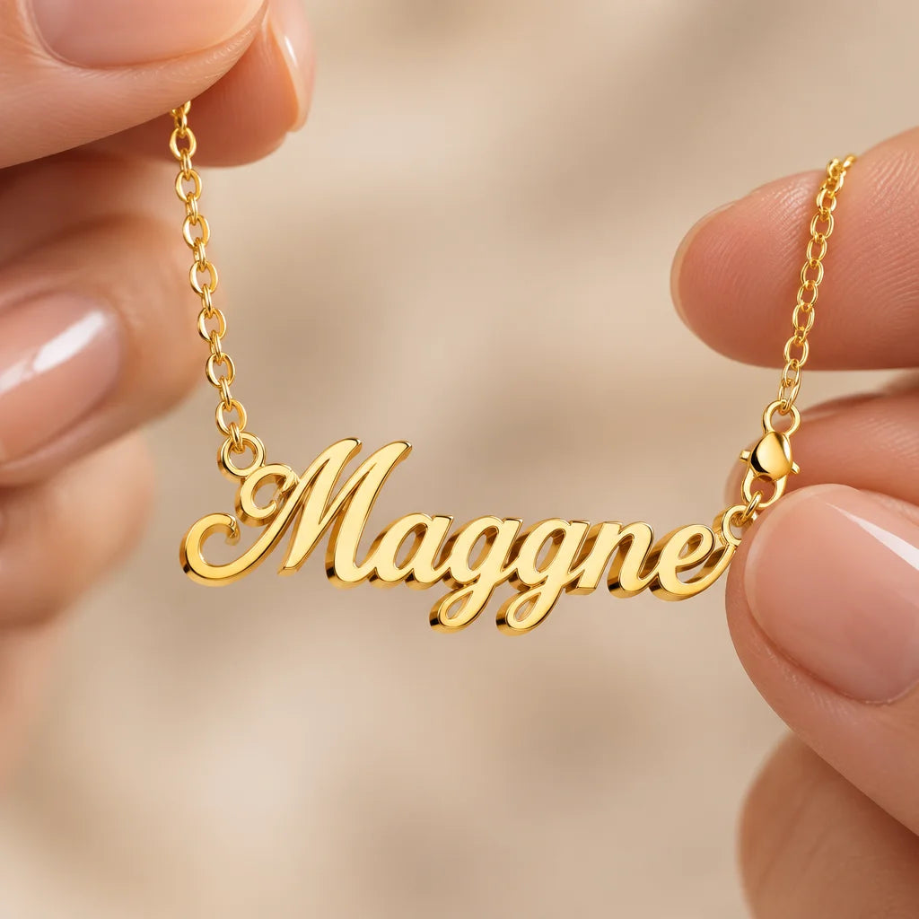 A polished gold stainless-steel cursive name pendant joined to its fine chain, exact lettering and d