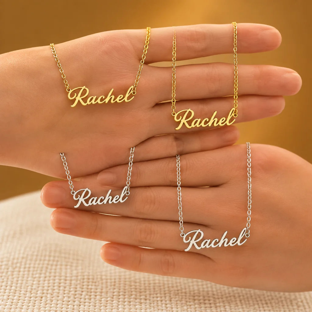 A gold stainless-steel personalized name necklace with a fine chain and cursive pendant, sharp and l