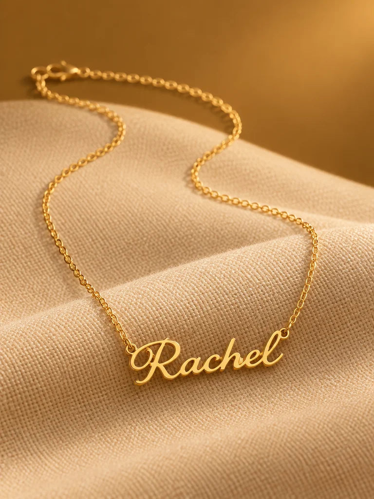 A complete gold stainless-steel personalized name necklace with a fine chain and continuous cursive