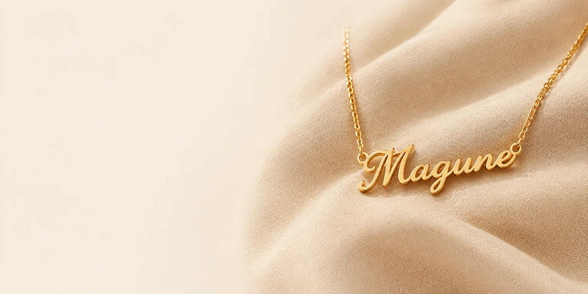 A large gold stainless-steel personalized name necklace with a fine chain and a continuous cursive p